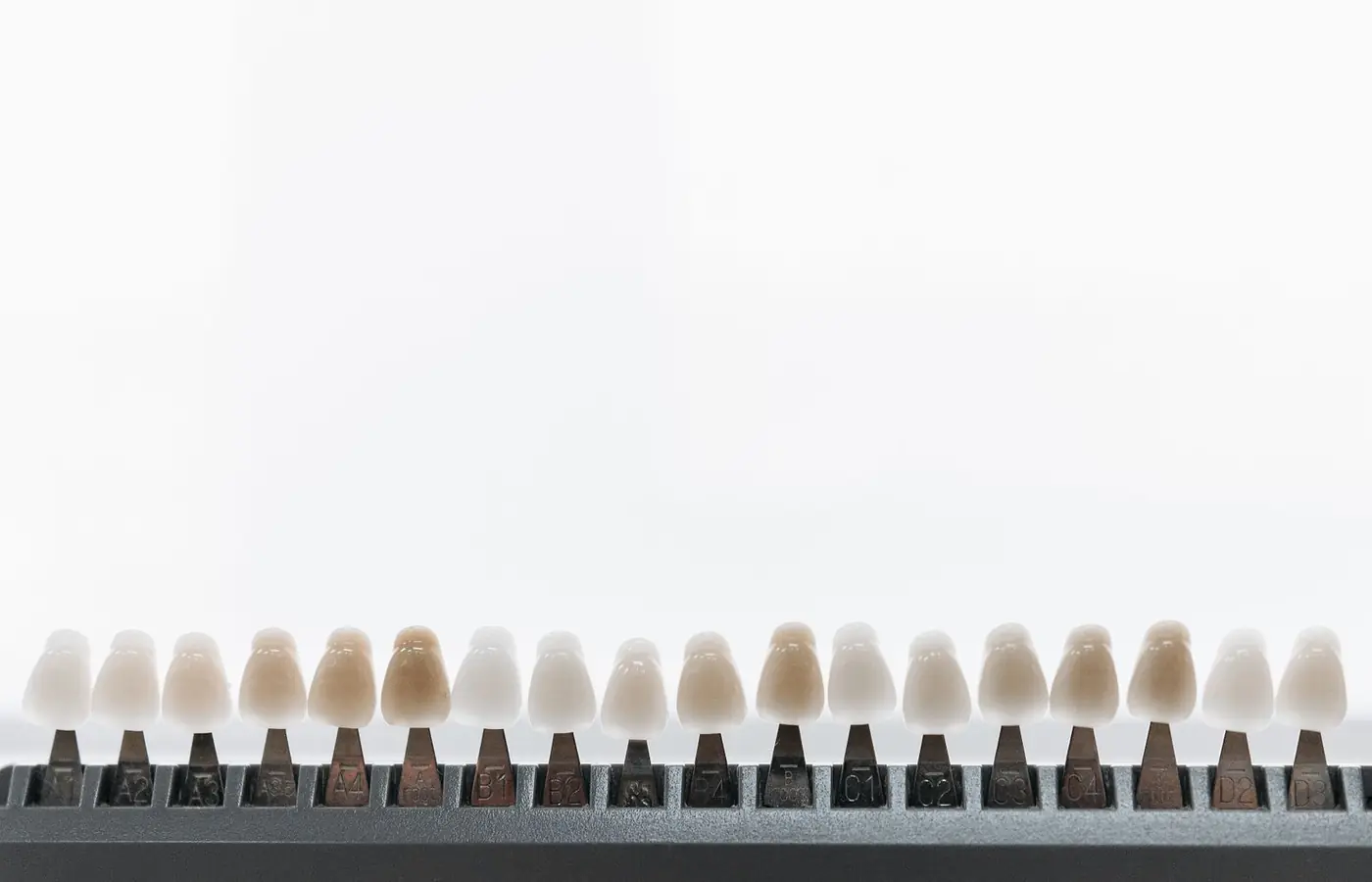 Guía de color dental con distintas tonalidades usada para elegir el tono en carillas y blanqueamiento